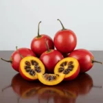 Fresh, ripe tomate de arbol (tamarillo) on a rustic wooden table.